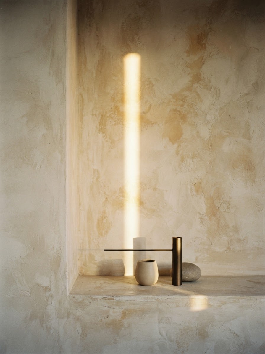 A shaft of warm light through a calm, neutral space